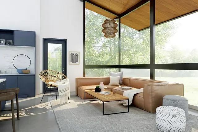 Living con ventanales y sillones de cuero