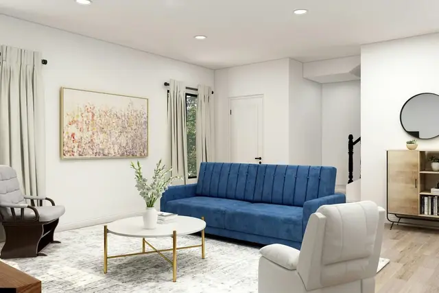 Living con sofá azul y mesa redonda